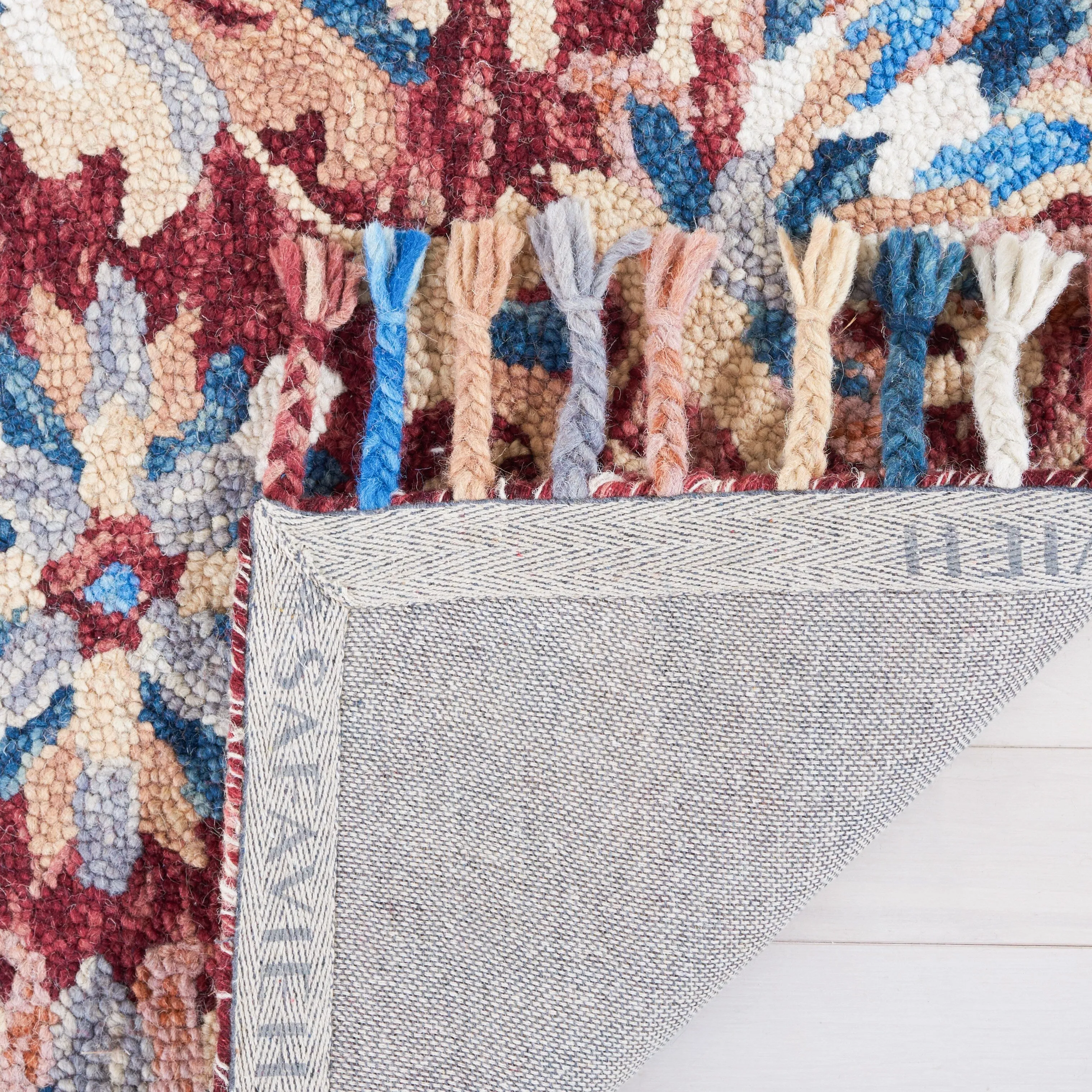 SAFAVIEH Handmade Aspen Orane Floral Braided Tassel Wool Rug