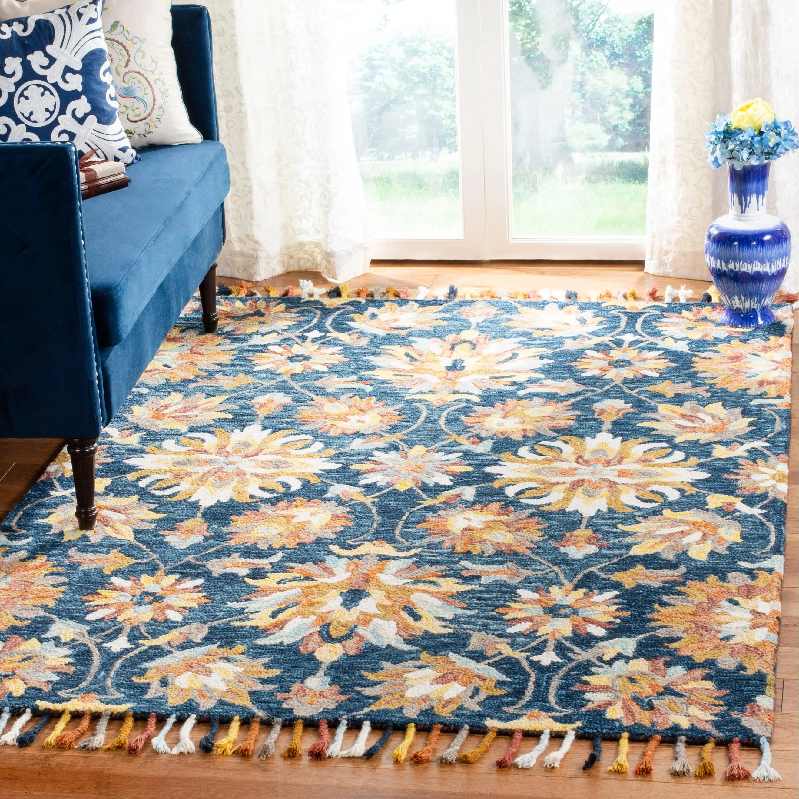 SAFAVIEH Handmade Aspen Orane Floral Braided Tassel Wool Rug