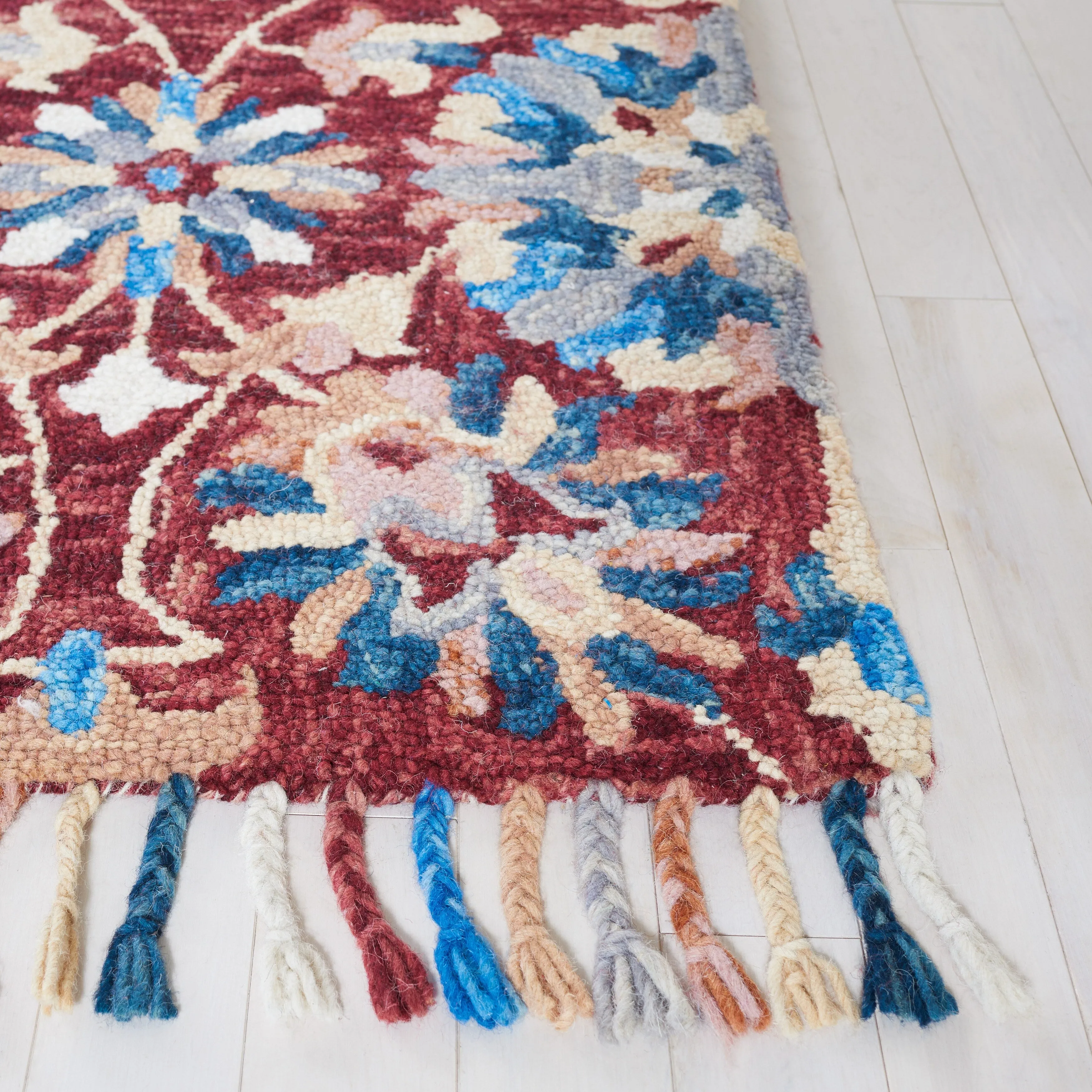 SAFAVIEH Handmade Aspen Orane Floral Braided Tassel Wool Rug